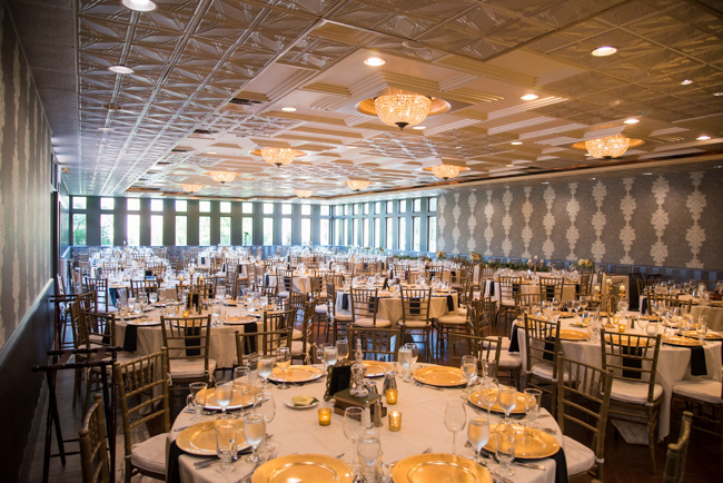 A reception space is filled with round tables and chairs.