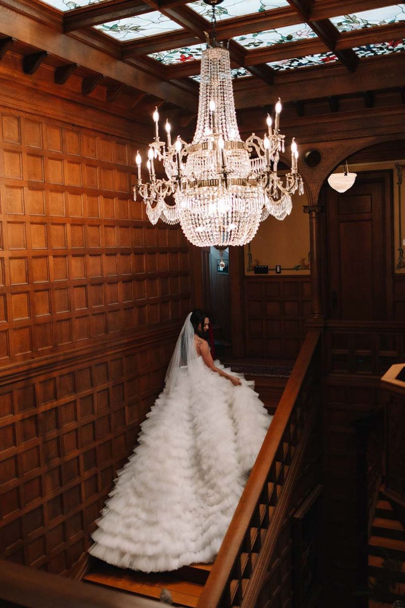 Bride on mansion staircase
