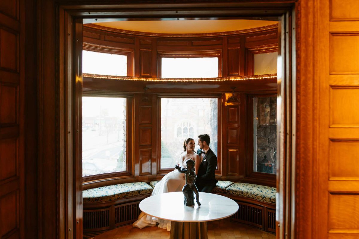 Bride and groom in mansion library