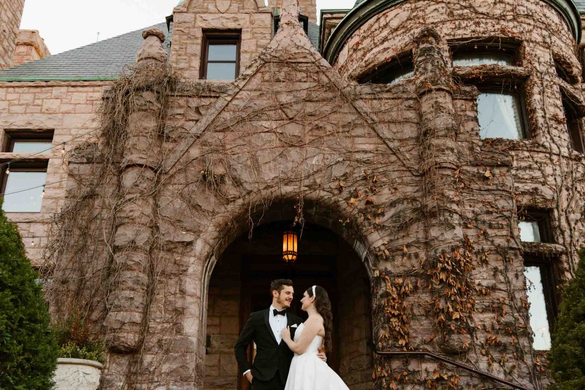 Bride and groom outside the mansion